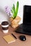 Workplace with notebook,mouse wireless and hyacinth on a brown background.