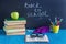 Workplace pupil Books Stationery Glasses and green Apple on blu