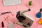 Workplace scientist / doctor - microscope, pills, syringe, eyeglasses, chemical flasks with liquid on pink wooden table