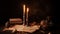 Workplace of a scientist or writer of past centuries by candlelight