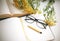 A workplace where on a table with books, glasses, a pencil and a tansy