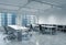 Workplaces in a bright modern loft open space office. Empty tables and docents\' book shelves. Singapore panoramic view. A concept