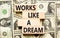 Works like a dream symbol. Concept words Works like a dream on wooden cubes. Beautiful background from dollar bills. Business