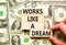 Works like a dream symbol. Concept words Works like a dream on wooden cubes. Beautiful background from dollar bills. Businessman