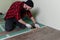 Works man installs laminate. Repair of the apartment, laying laminate flooring