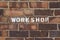 Workshop sign brick wall