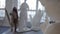 workshop of talented artist, man is painting on canvas, white sculptures are standing around