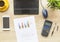 Workspace with coffee cup, smartphone, paper, notebook, calculator and laptop on wooden background. Top view. Desktop. Accounts