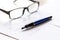 Workspace with document, glasses and pen for sign for businessman day