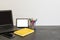 Workspace with laptop, yellow diary, photo frame, color pensils