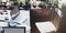 Workspace table with computer laptops and green houseplants