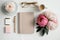 Workspace top view with pink blush blossom peonies, diary notebook and glasses. Bloom garden floral for template. Generative AI