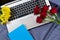 Workspace and workplace in bed with internet and laptop at bedroom background. Flowers roses and notebook with copy space and top