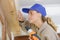 workwoman drilling window profiles in workshop