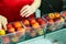 Workwoman hands checking peaches on sorting conveyor belt