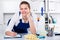 Workwoman of office cleaning service wiping dust on sleek table