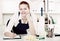 workwoman of office cleaning service wiping dust on sleek table