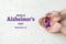 World Alzheimer& x27;s day. September 21. International Epilepsy Day. Hands holding purple ribbon on white background