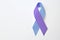 World Arthritis Day. Blue and purple awareness ribbon on white background, top view. Space for text