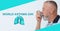 World asthma day. Man using inhaler on background, banner design