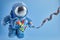 World Autism awareness day background. Blue plush astronaut toy with puzzle heart, autism symbol, on blue background