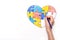 World Autism Awareness day. Children`s hand draws heart from multi-colored puzzles. Mental health care concept