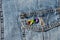 World autism awareness day. Closeup view of denim jacket with metallic pin brooch. Autism infinity rainbow symbol sign