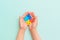 World autism awareness day. Hands of small child holding colorful puzzles. Concept - Autistic Pride Day. ASD. Banner. Top view.