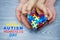 World Autism Awareness day, puzzle or jigsaw pattern on heart with autistic child`s and father hands