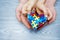 World Autism Awareness day, puzzle or jigsaw pattern on heart with autistic child`s and father hands