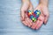 World Autism Awareness day, puzzle or jigsaw pattern on heart with autistic child`s hands