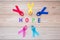 World cancer day February 4. colorful awareness ribbons; blue, red, pink and yellow color on wooden background for supporting