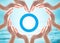 World diabetes day concept with blue circle symbolic logo among protective heart-shape hands for diabetic disease prevention