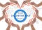 World diabetes day concept with blue circle symbolic logo among protective heart-shape hands for diabetic disease prevention