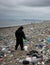 World Earth Day a single person cleaning up a polluted beach