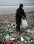 World Earth Day a single person cleaning up a polluted beach