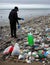 World Earth Day a single person cleaning up a polluted beach