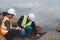 World environment day concept ,Thai Asian Female engineering working with a tablet laptop at sewage treatment plant