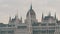 The world-famous building of the Hungarian Parliament in Budapest in the Gothic style in cloudy weather.