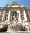 The world famous Trevi Fountain in italian city of Rome on a sunny day with cloudless sky