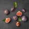 World food day. Ripe sweet figs with green leaves on a black background