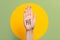 World greeting day. Raised female hand with the inscription Hi. Green with yellow ball background. Copy space