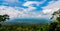 World heritage. Green dense tall trees on the mountain and blue sky and cumulus clouds.