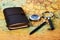 World map with business guide book, magnifying glass and compass, close-up