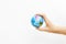 World map foam Earth Globe stress relief bouncy ball in girl hand on white background