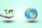 World map showing open hand with green leaves. World on a pastel background. color.Environment concept.Ecology concept.The