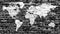 World map in white on grunge black bricks wall