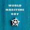 World Maritime Day text on grungy blue turquoise wooden background. Turquoise wood board with white steering wheel