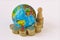 World planet and raising coins stack with pawn - Concept of global economy