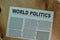 World Politics text in headline isolated on Brown burlap laying on table. Newspaper concept